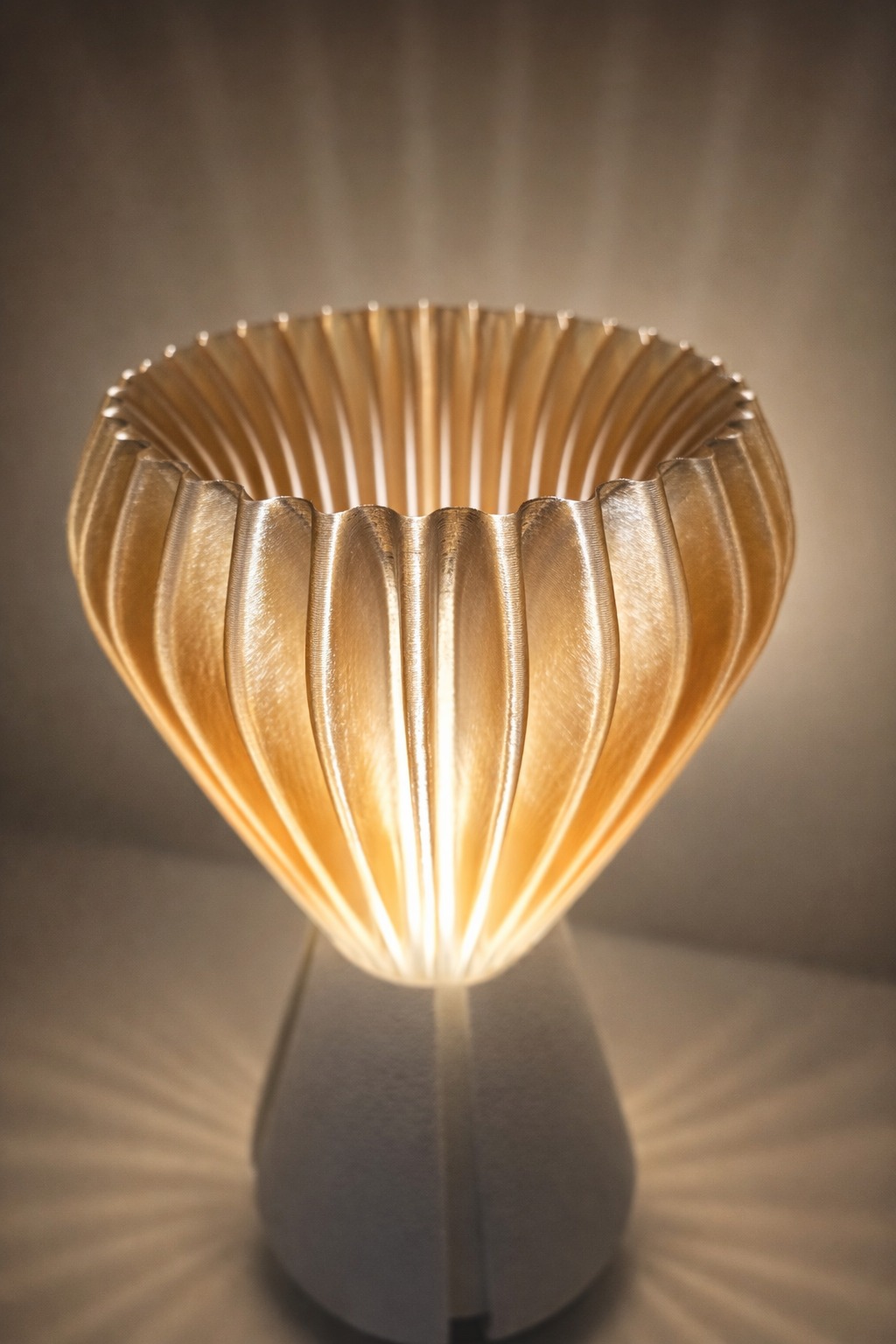 Top view of the Sakumi lamp showing the petal-like fluted shade glowing from within