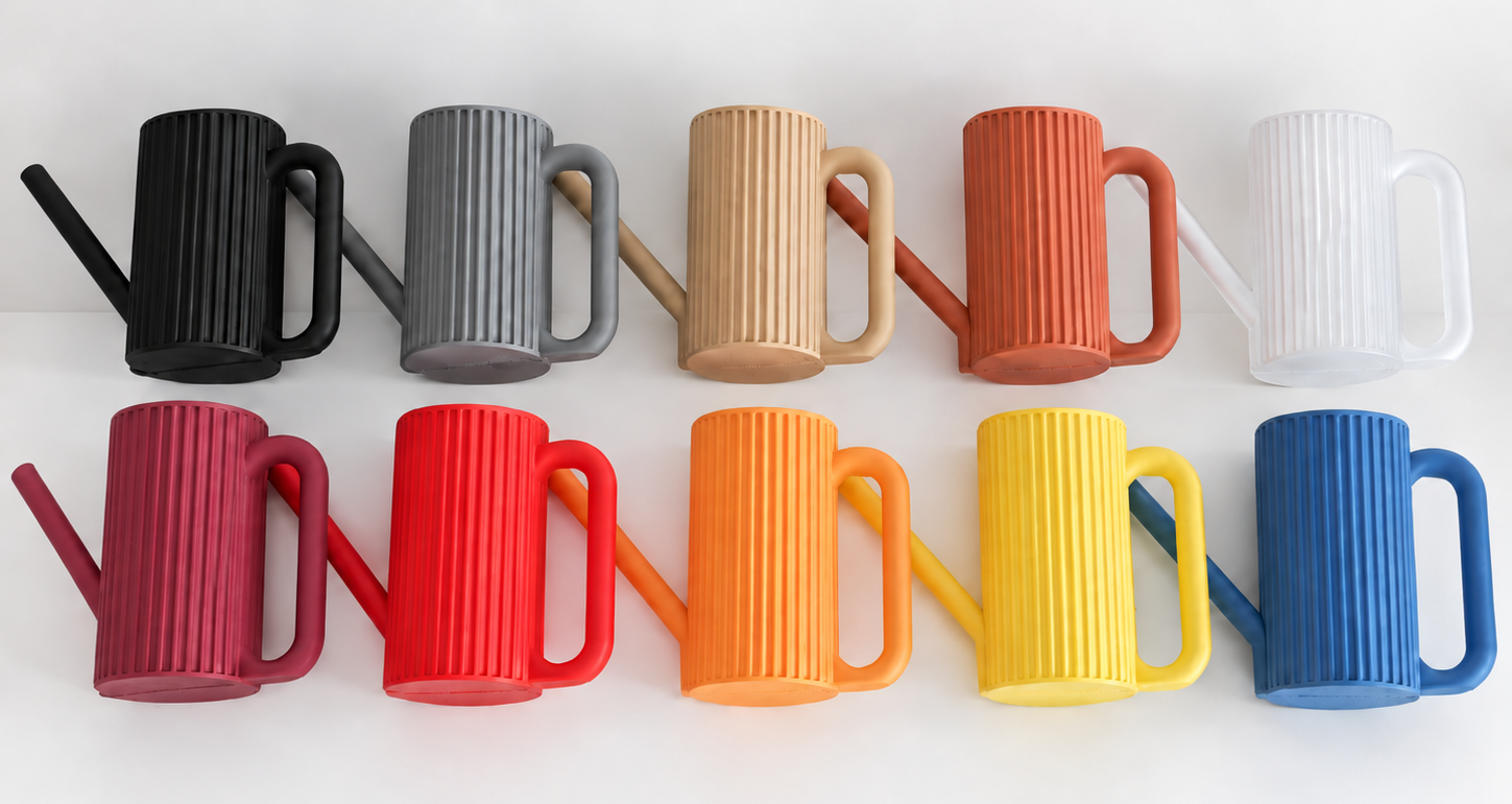 All ten Scandinavian watering can colourways lined up — charcoal, slate, sand, terracotta, white, magenta, red, orange, yellow and cobalt